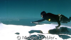 Apnea Diver under ice, Morrisons Quarry, Quebec, Canada. ... by Michael Grebler 